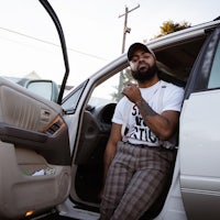 a man sitting in the back seat of a car