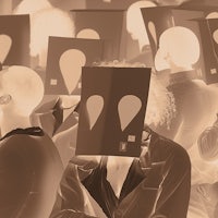 a group of people with paper masks on their heads
